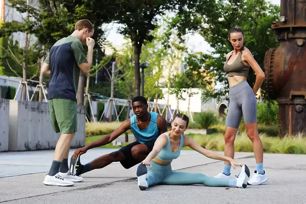 Four people working out in a park 