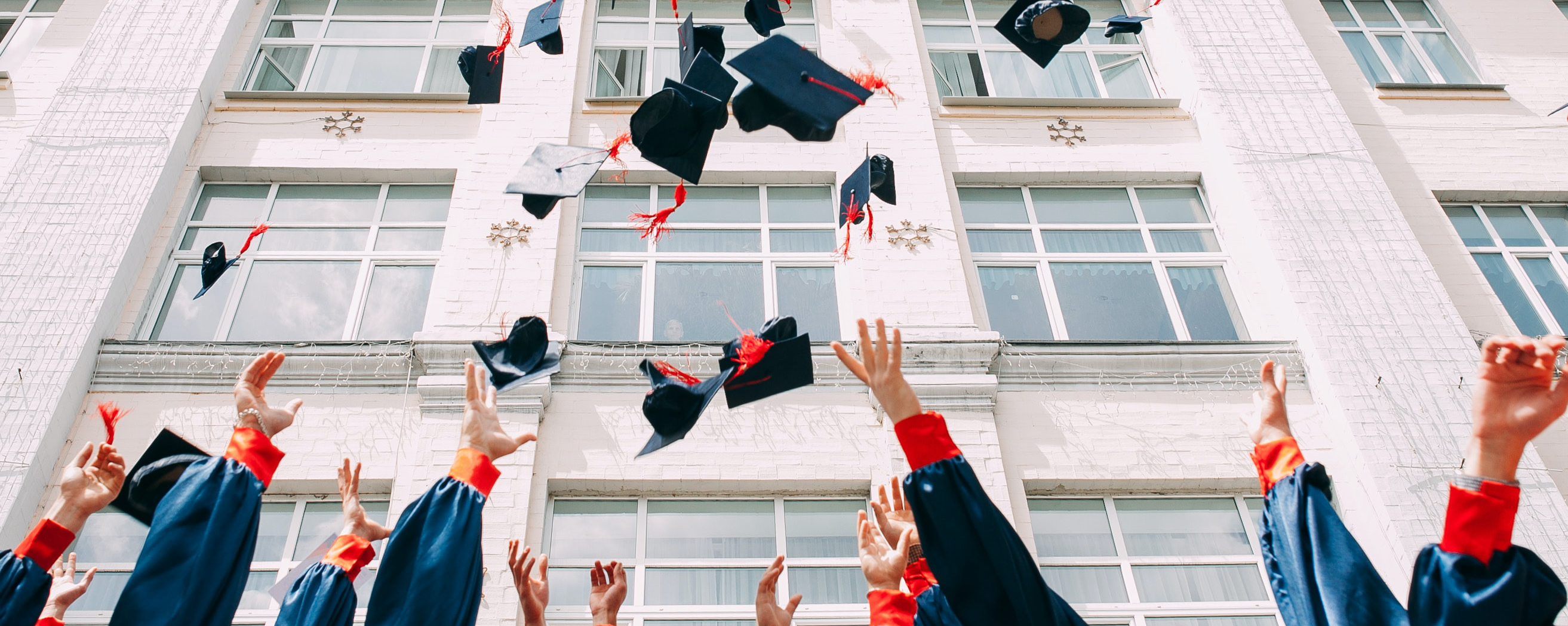 graduates throw their hats into the air