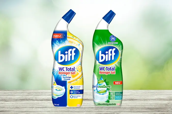 Biff bottle standing in front of a green background.