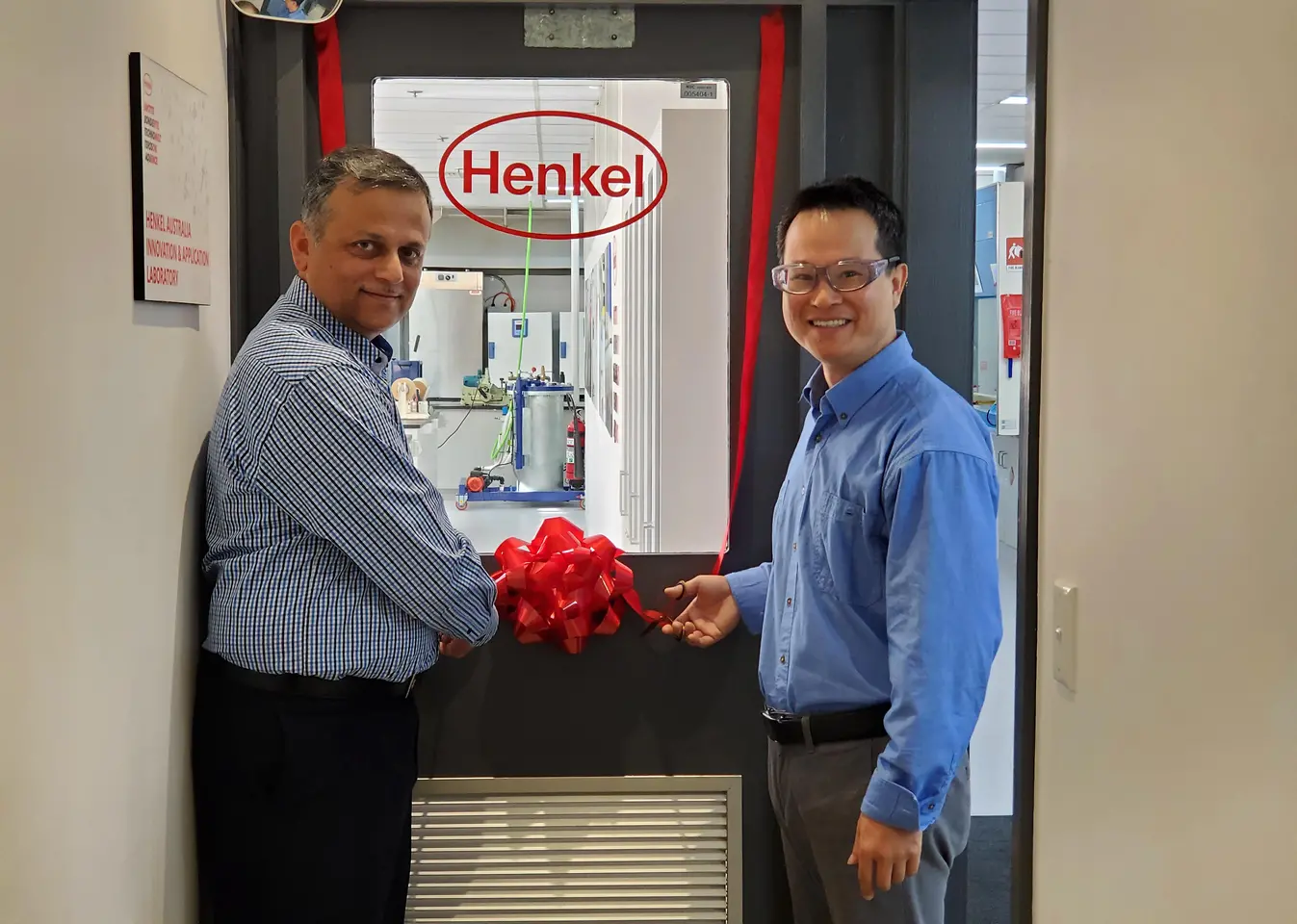 Aamir Qureshi (left), Operations & Supply Chain Manager, and Stephen Liu (right), Senior Chemist, cutting the ribbon to mark the official opening of the upgraded Innovation and Application Lab of Adhesive Technologies in Sydney.
