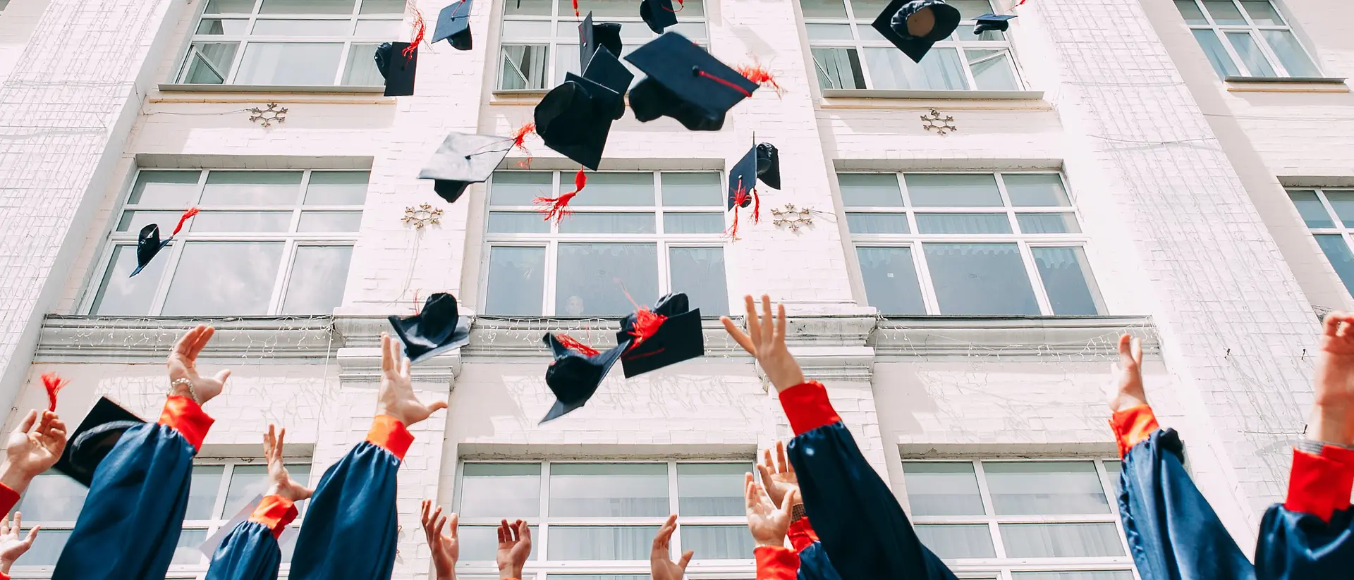 graduates throw their hats into the air
