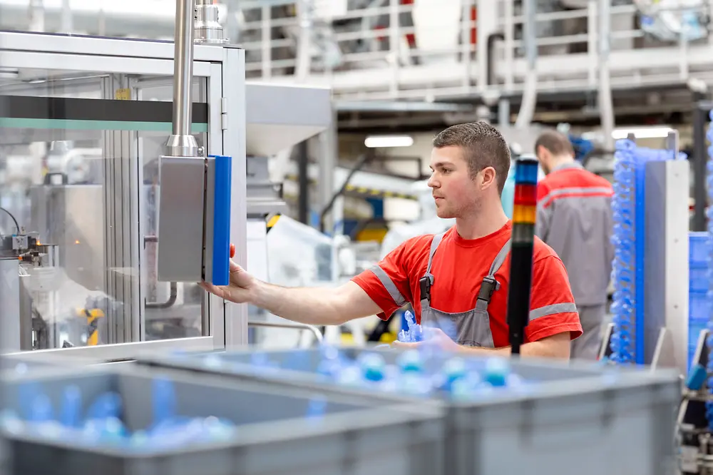 An employee operating a production machine in the Henkel plant in Kruševac, Serbia