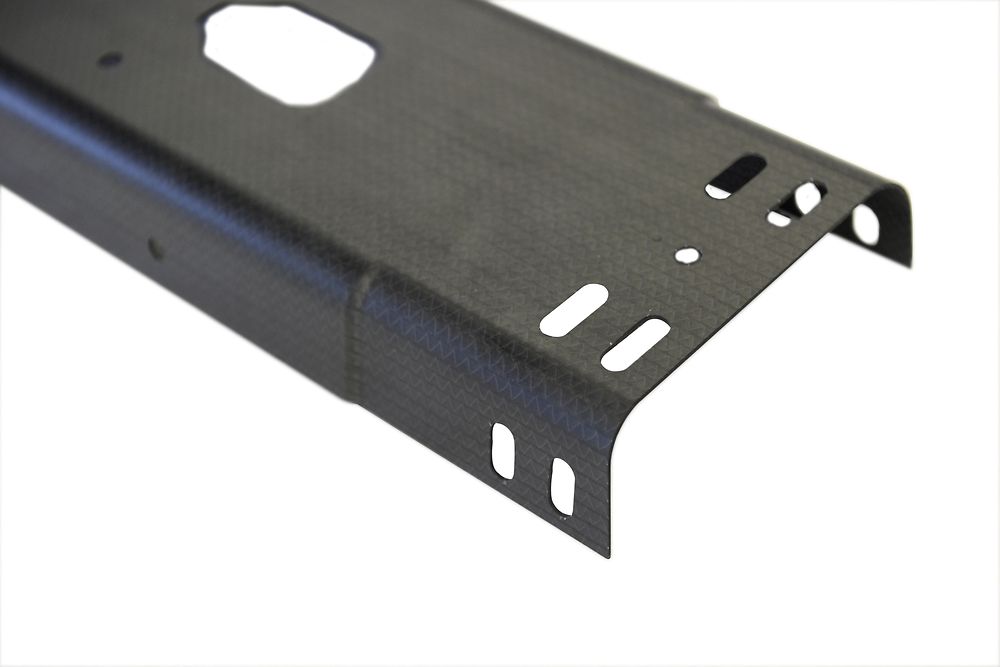 The component: a lightweight cover section for central consoles, manufactured with carbon fibers from Zoltek and the matrix resin Loctite MAX 2 from Henkel.