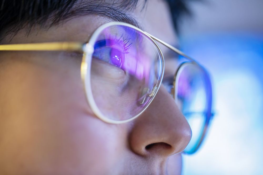 Close up of a woman with glasses.