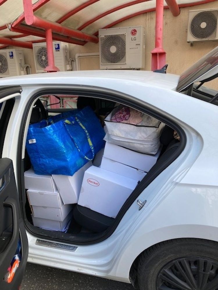 A fully loaded car packed with product donations from Henkel.
