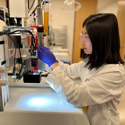 Henkel Associate Application Engineer Olivia Shin works on dispensing equipment