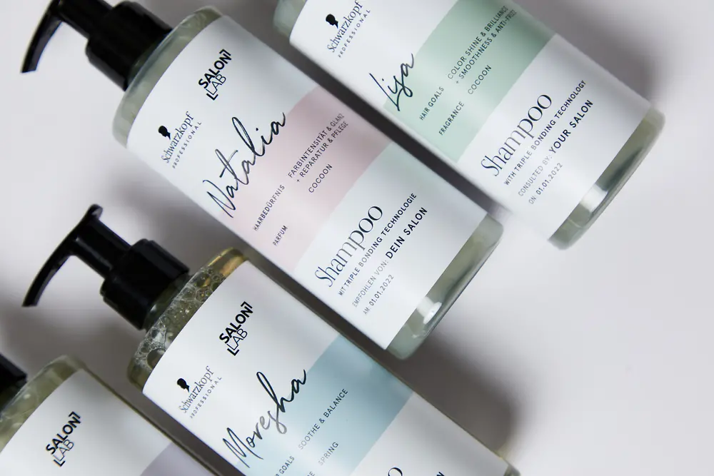 Four SalonLab shampoos with an individualized label.