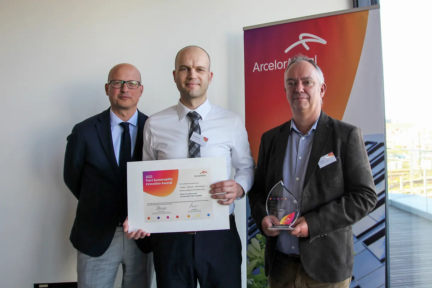 
From left to right: Volker Mansfeld, Vice President Metals EIMEA, Ronald Elemans, Key Account Manager Metal Coil, and Luc Vliex, Global Key Account Manager, receive the Paint Sustainability Innovation Award from customer ArcelorMittal on behalf of Adhesive Technologies.