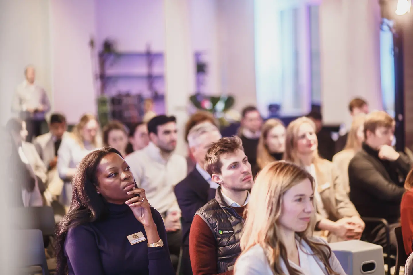 A seated audience that listens spellbound.