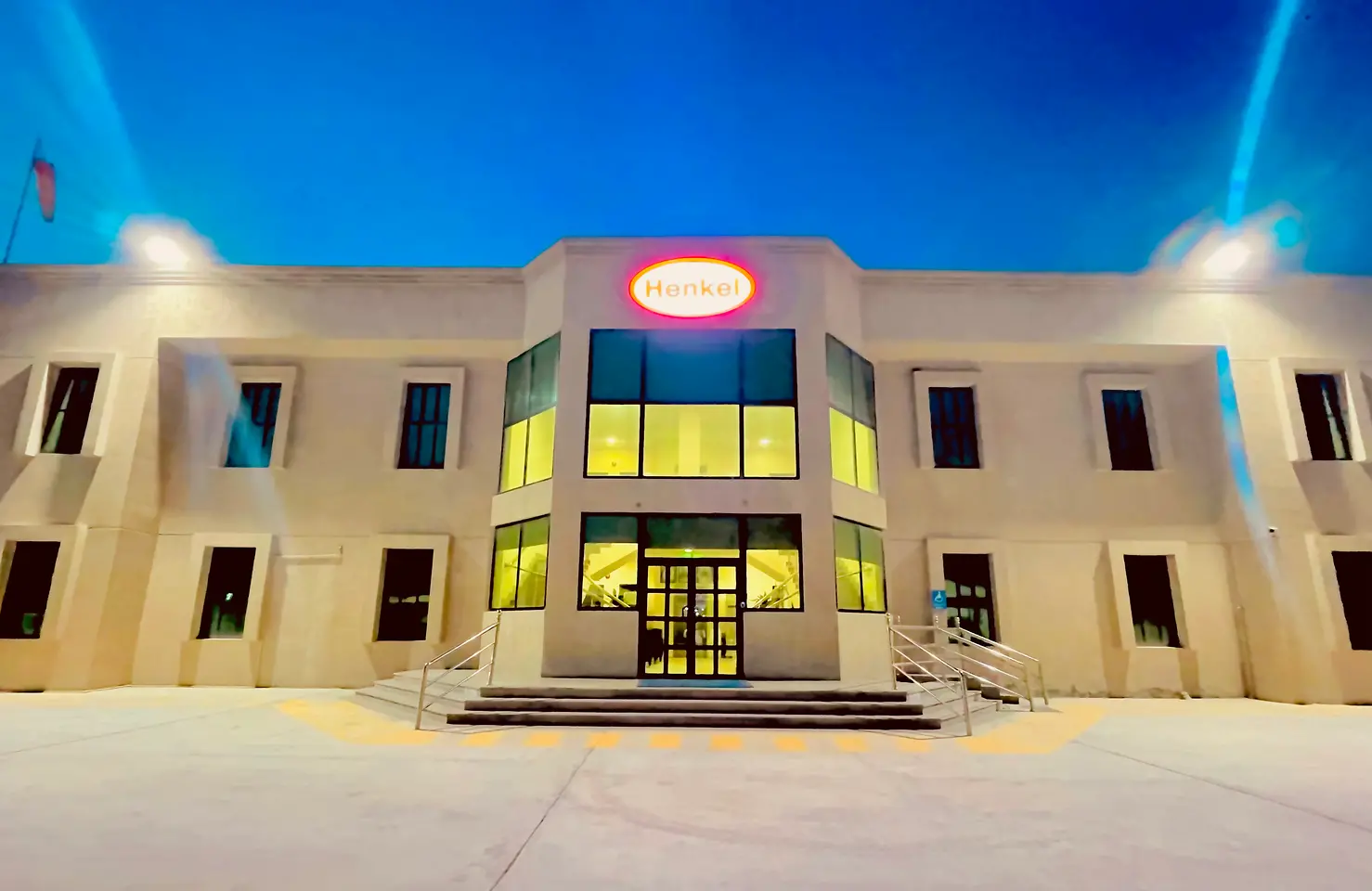 Front side of the Henkel building in Dammam with a bright Henkel logo in the middle of it.