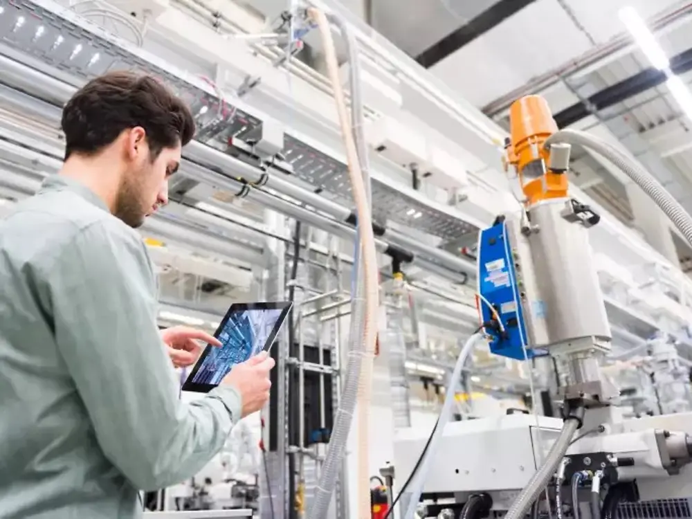 Man with a tablet in a production site