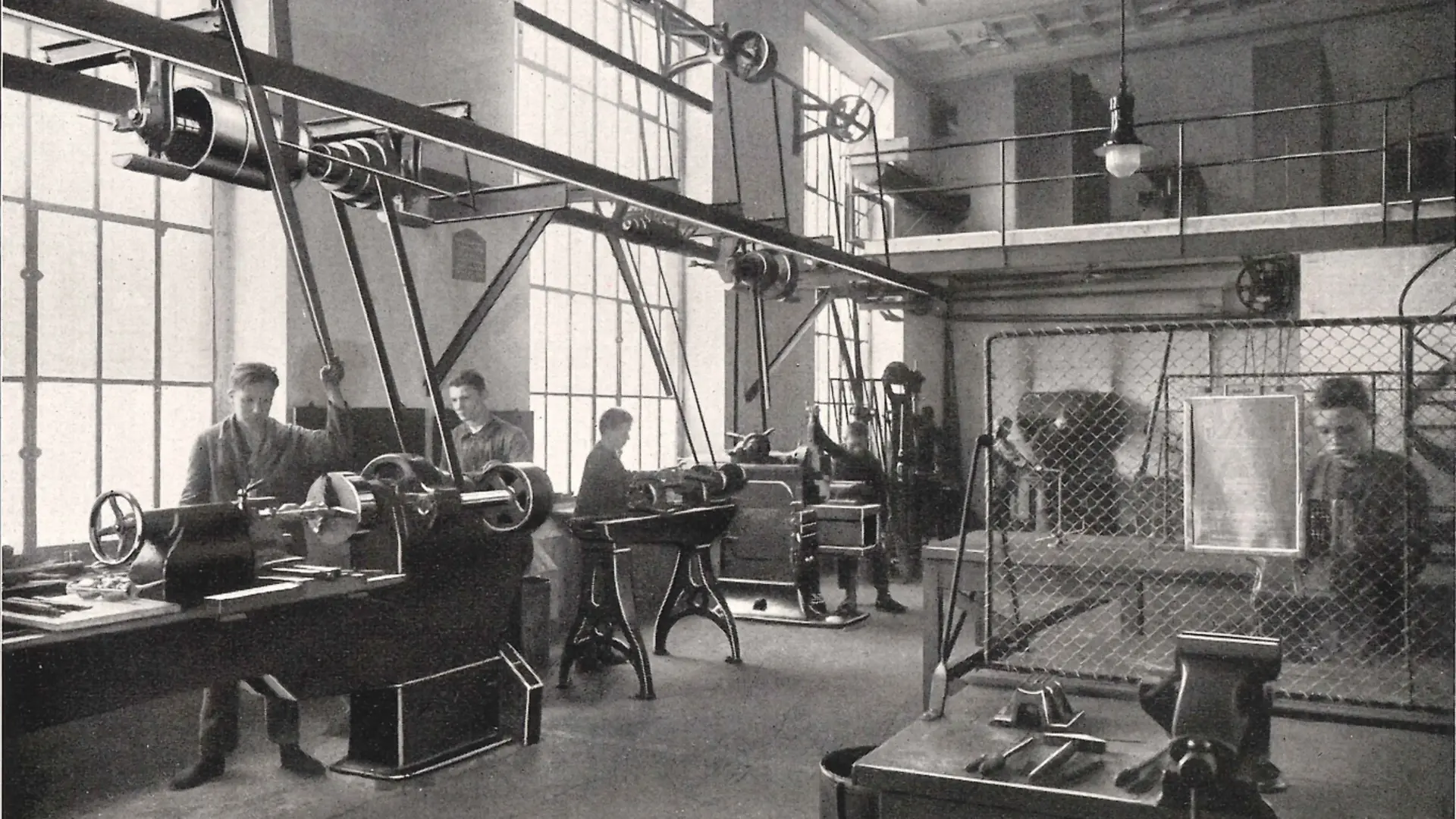 Apprentices working on machines in the metalworking workshop.