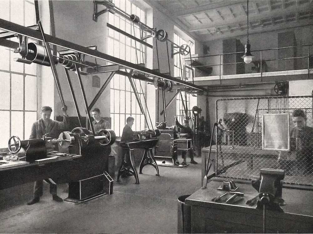 Apprentices working on machines in the metalworking workshop.