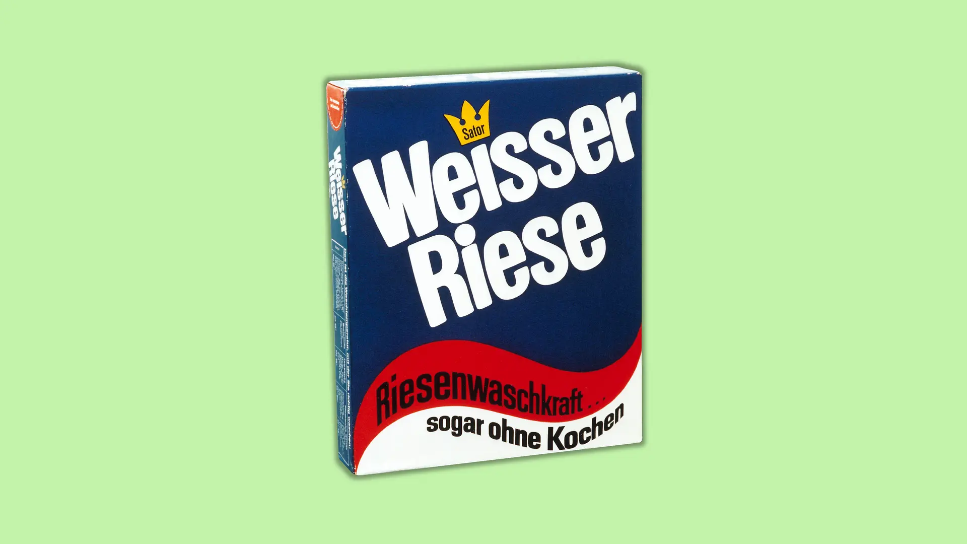 Packaging for the first Weißer Riese detergent . Two thirds of the packaging is designed in a dark blue and ends at the bottom with wavy shapes in red and white set one below the other. The brand name Weißer Riese is prominently displayed in large white letters on the blue background. The slogan “Giant washing power...” begins in the red waveform and ends with “even without boiling” in the white waveform.