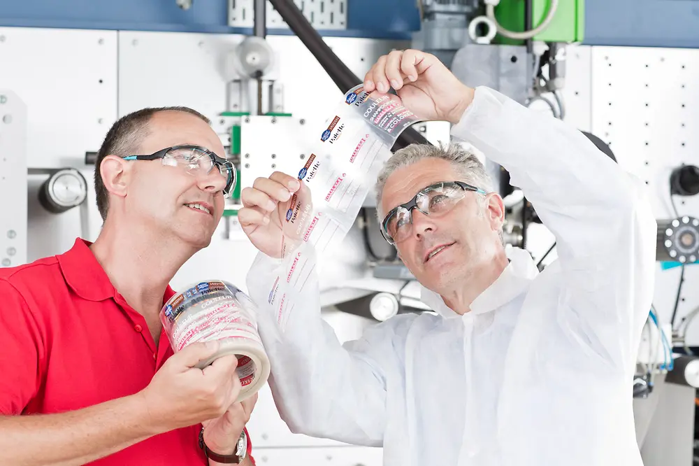 Two people looking at a label.