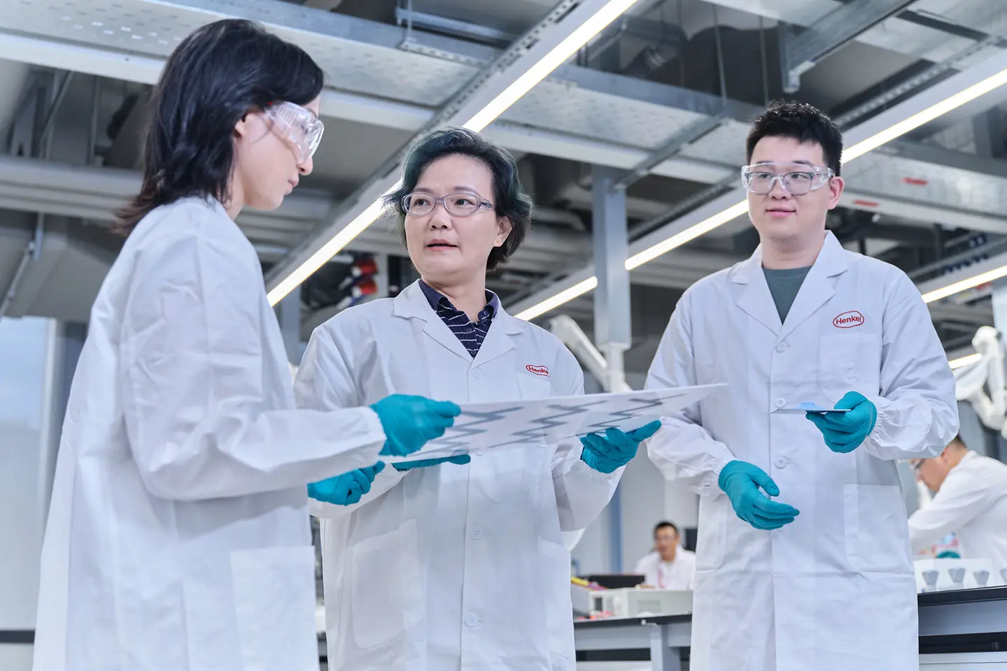 Laboratory technicians discuss thermal management tests