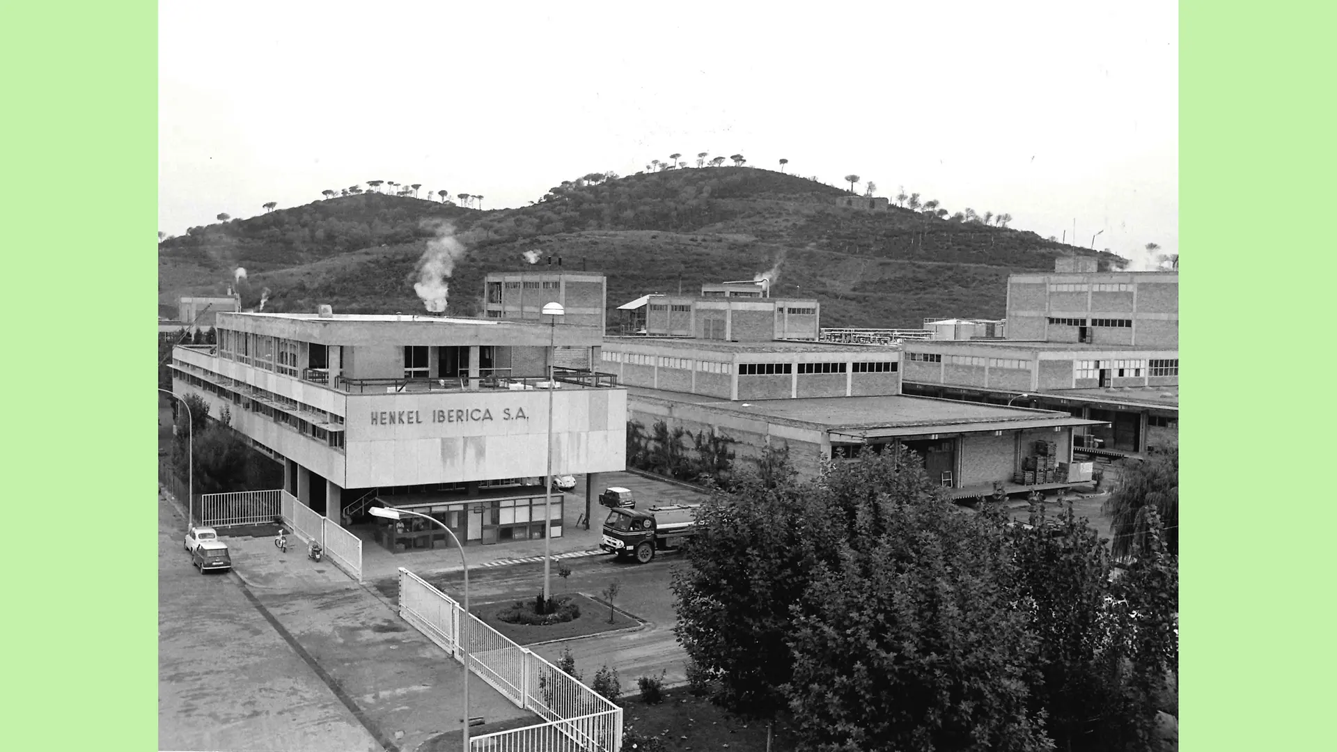 Black and white image of Montornès site’s exterior. The picture portrays the industrial complex with its various industrial buildings surrounded by the hills and mountains of the area.
