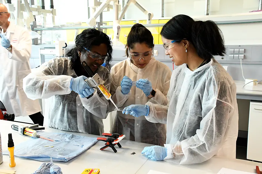 Collage of two images and a text field: the first picture shows three women working in a laboratory, the second shows a liquid.