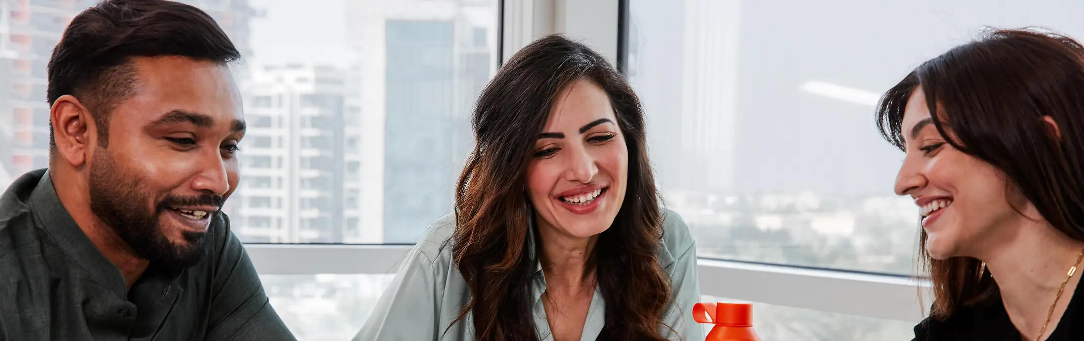 Collage of two images and a text field: the first picture shows three colleagues sitting together on a table, the second shows a structure.