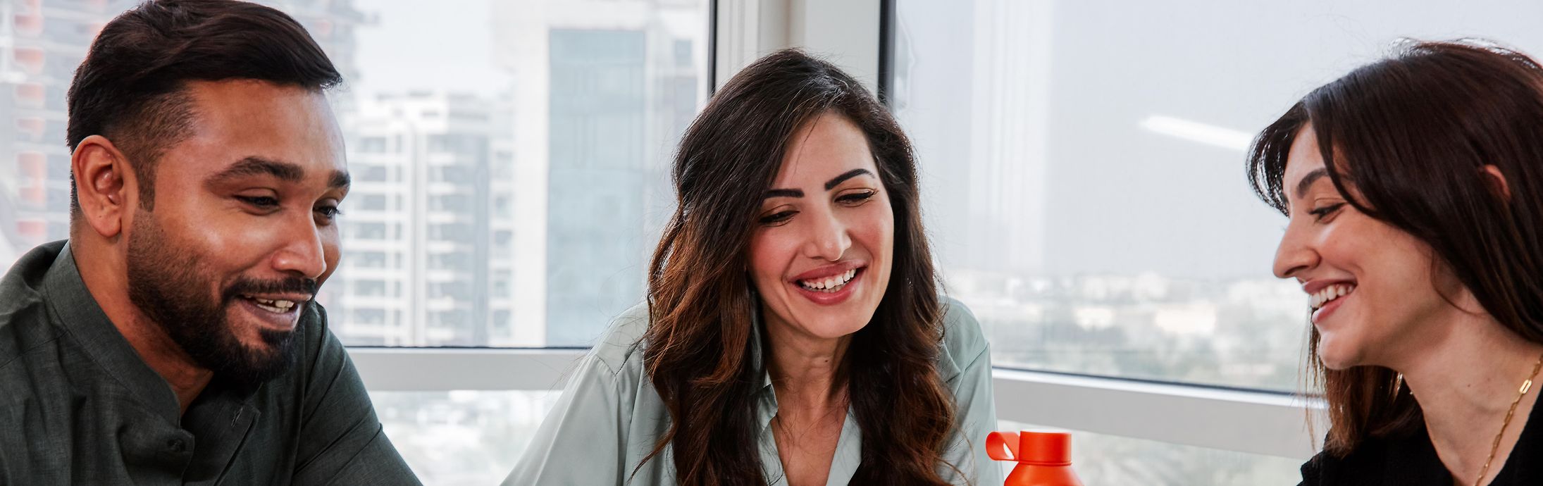 Collage of two images and a text field: the first picture shows three colleagues sitting together on a table, the second shows a structure.