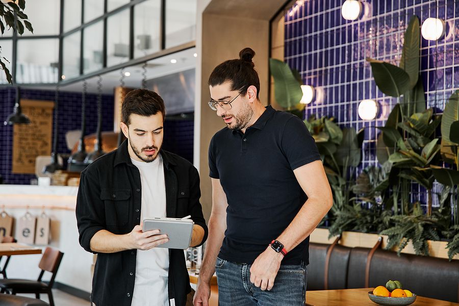 Collage of one image and a text field: the first picture shows two colleagues working together in a relaxed, casual office setting. The second picture shows a structure. 