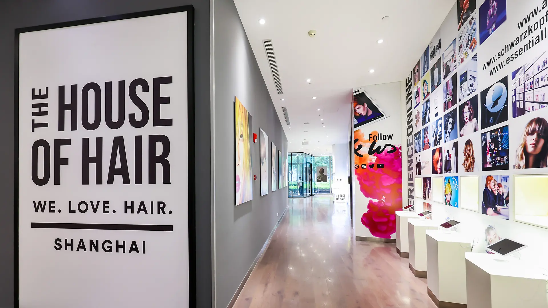 Modern hair academy interior with styling stations, mirrors, and HOH Shanghai branding.