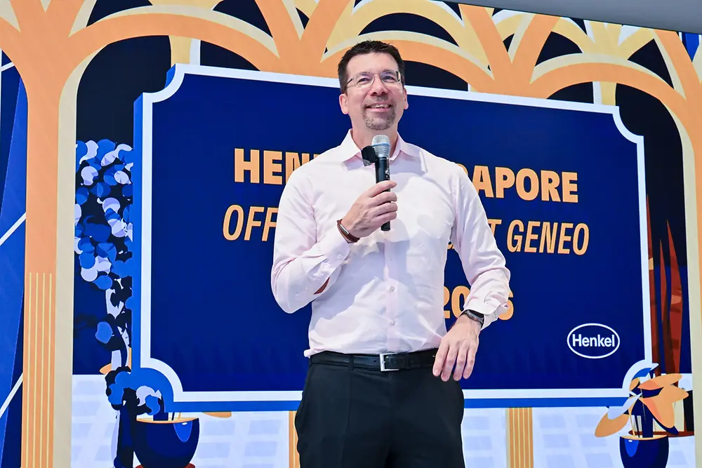 A man holding a mic and giving a speech. 