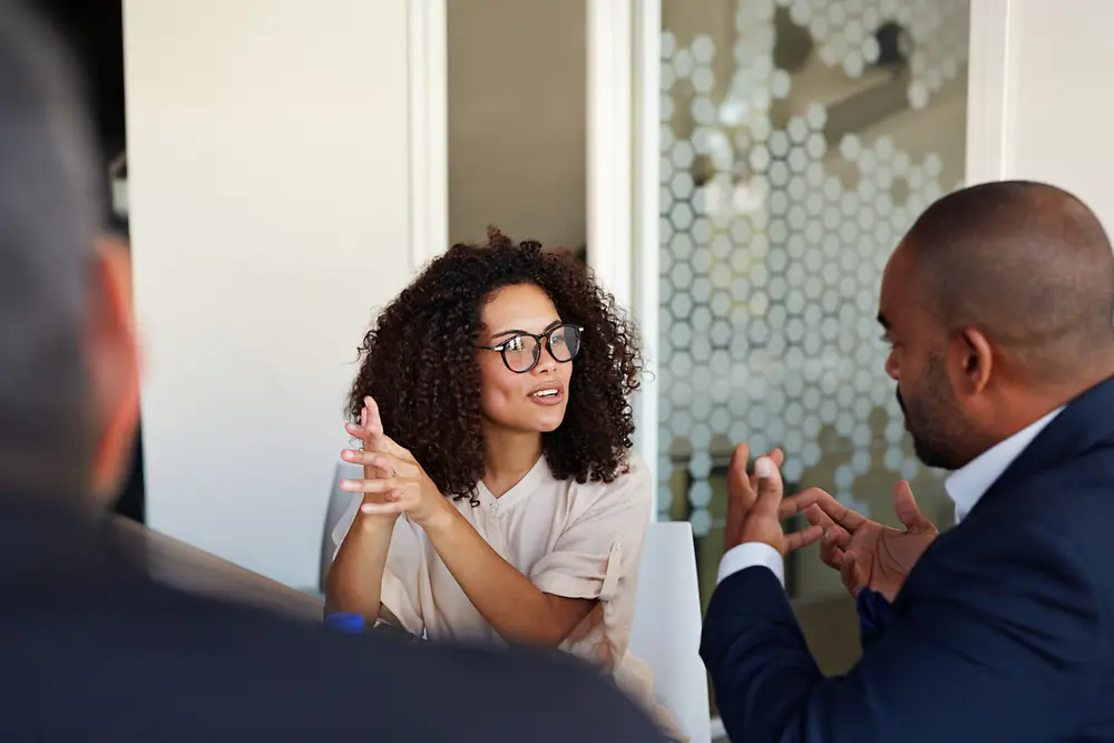 Colleagues collaborating during a business meeting with one person explaining an idea.