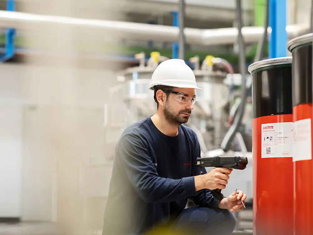 
Operator handling packaged adhesives from mixer process