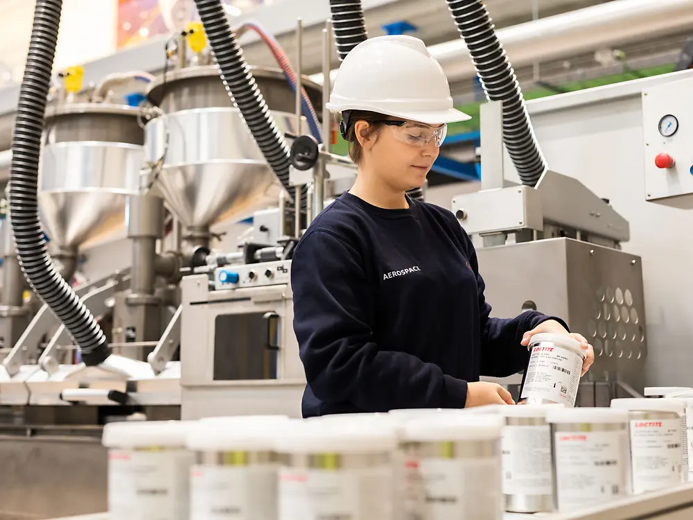 
Operator filling adhesive products from mixer