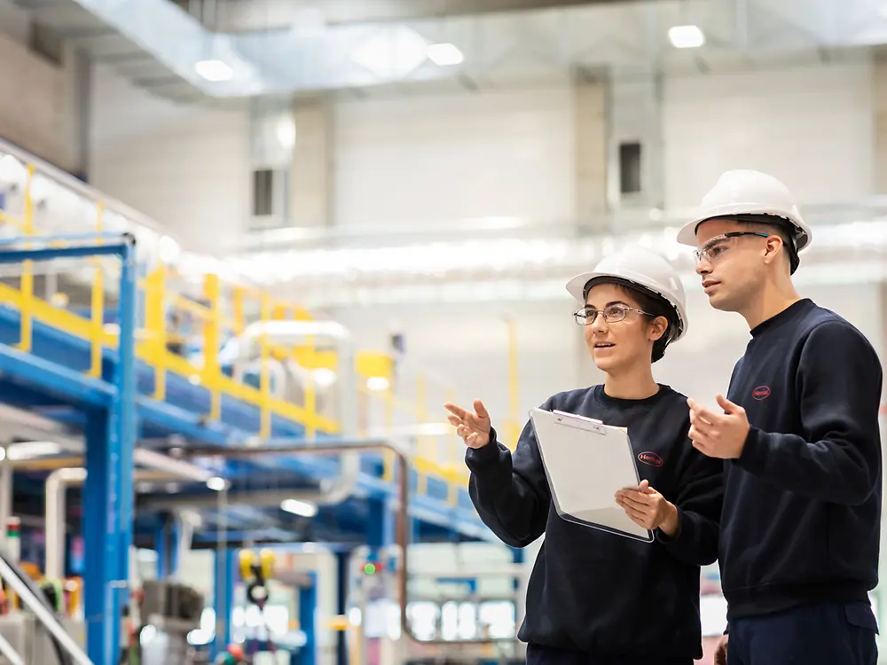 
Operators reviewing process parameters at mixer unit