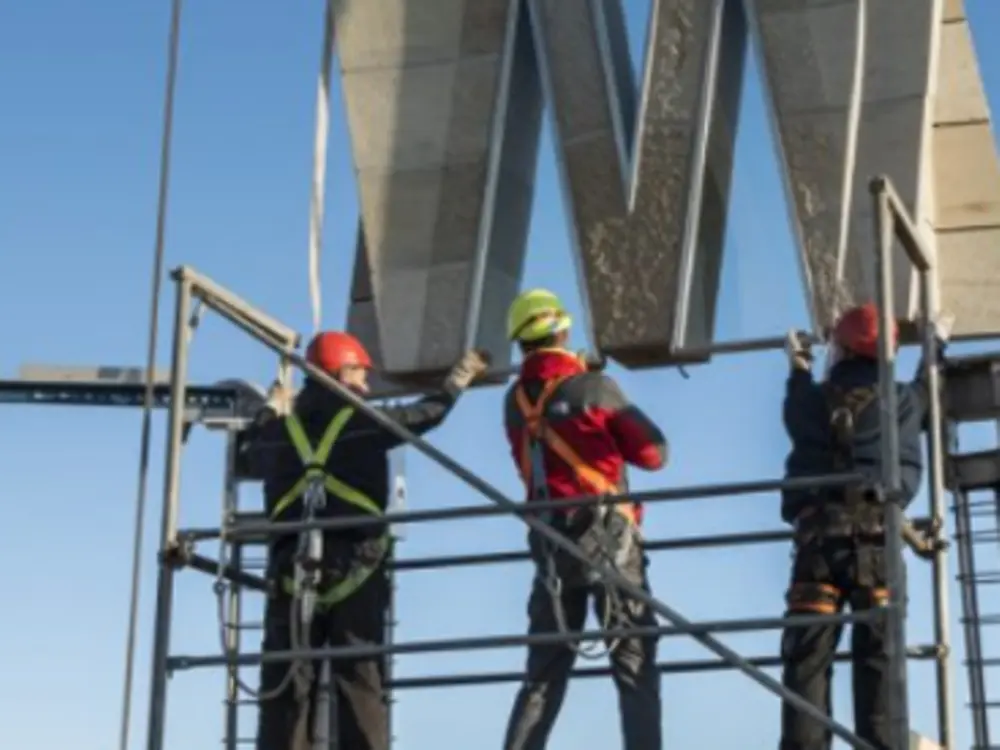 Assembly of prefabricated structural panels at height during tower construction