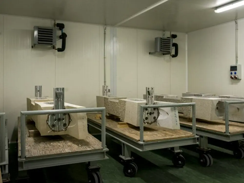 Curing area where bonded stone and steel components are kept under controlled temperature
