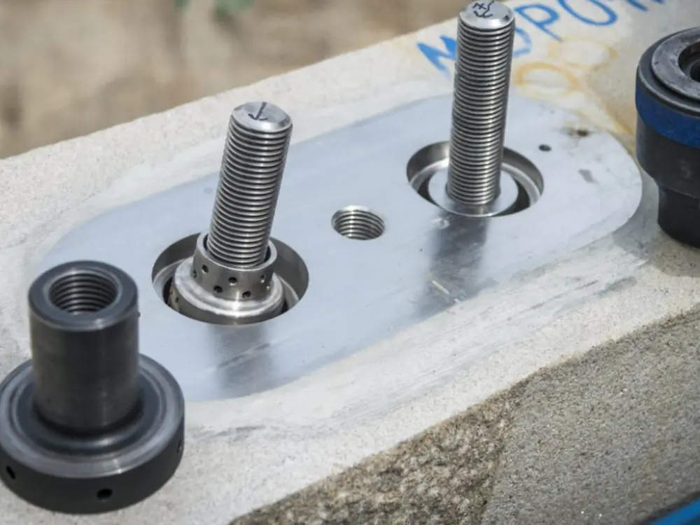 Steel inserts positioned in stone elements before adhesive bonding application