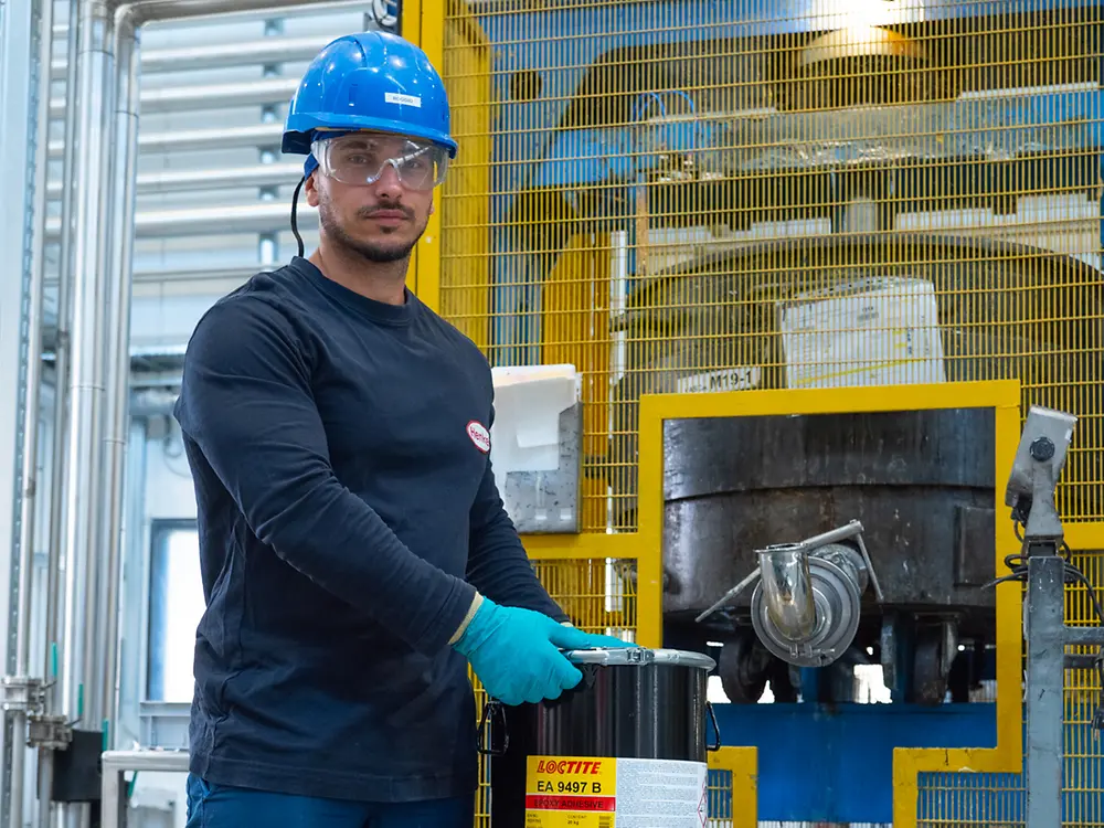 Casarile Plant - Man positioning a bucket of LOCTITE EA 9497 on a pallet