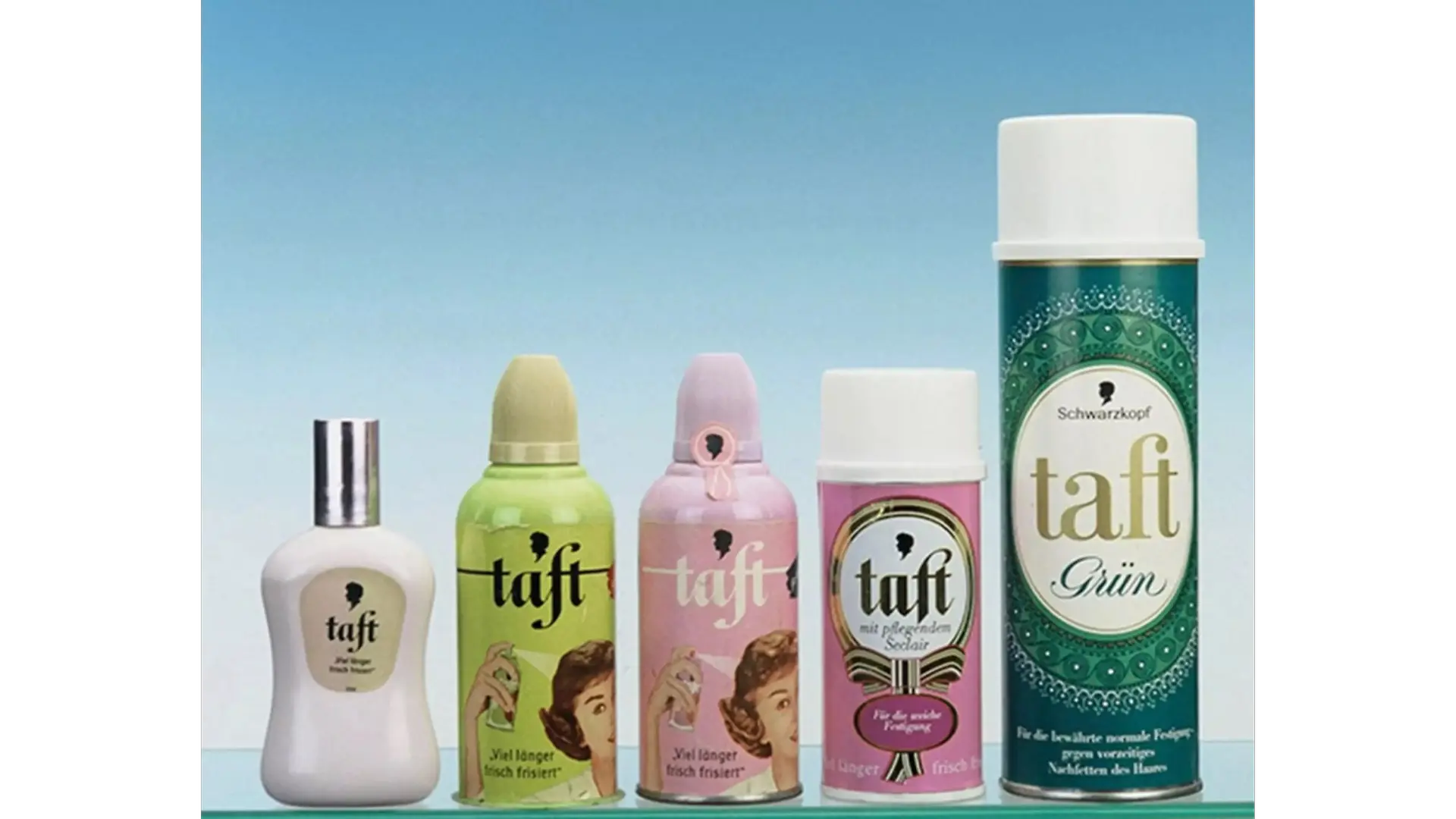 Assortment of vintage Taft hair styling products displayed against a blue background.