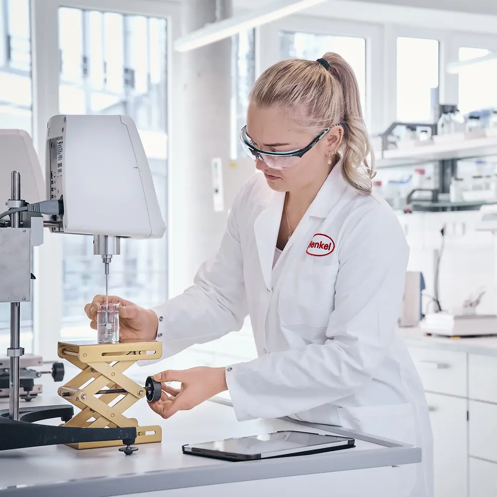 A female researcher in the hair laboratory analyzing hair strands.