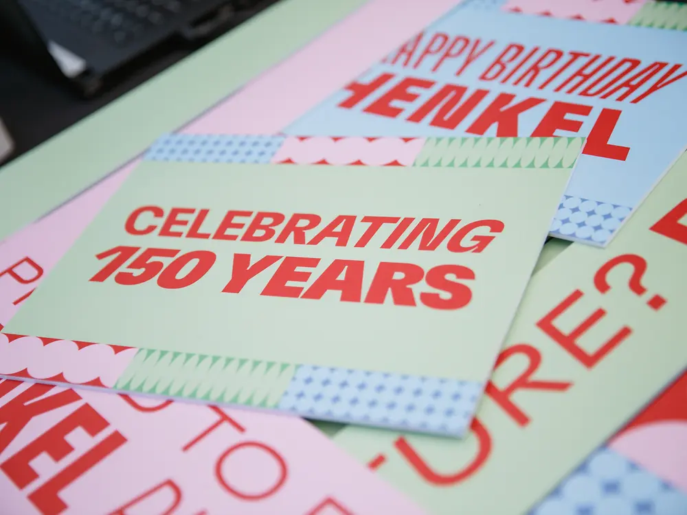 A selection of anniversary cards featuring the messages “Celebrating 150 Years” and “Happy Birthday Henkel.”