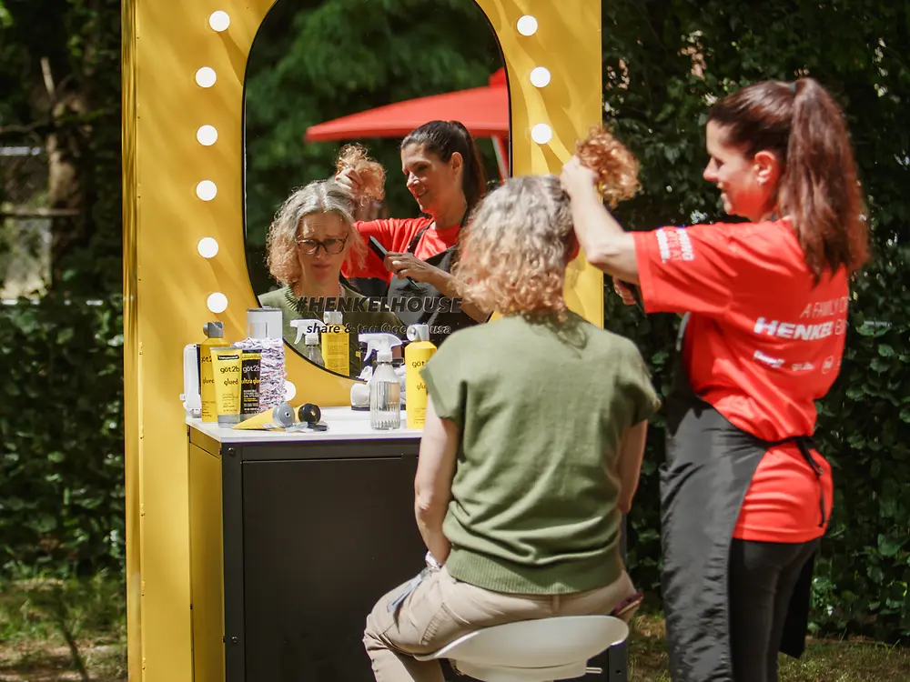 A got2b styling station offers visitors a hair styling experience during a Henkel anniversary event.