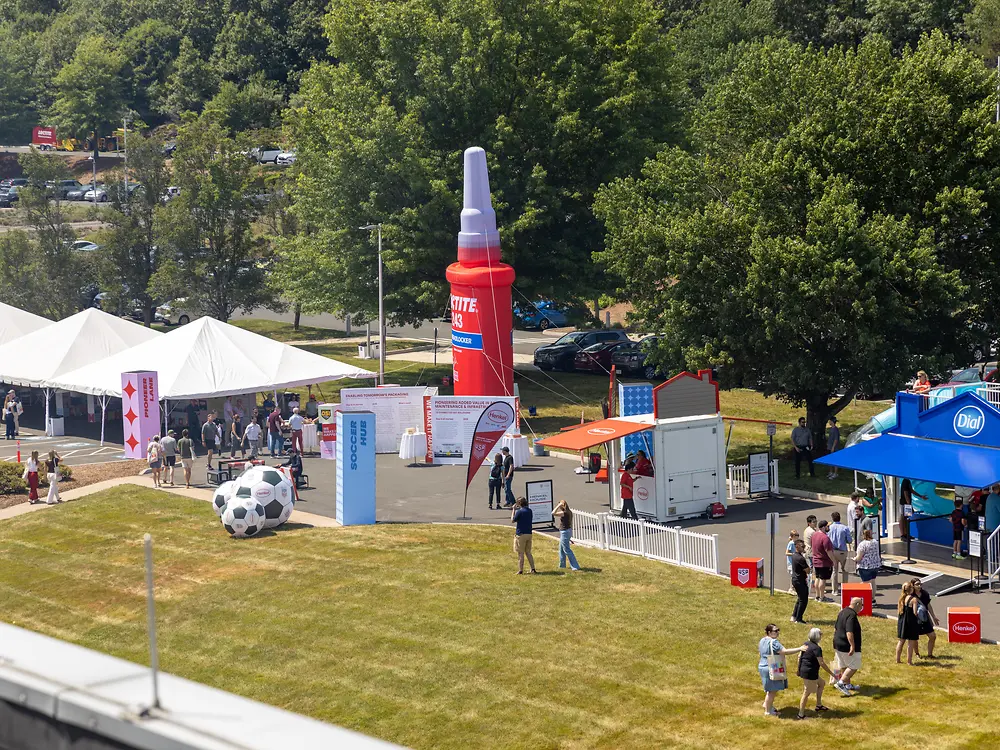 An outdoor festival area features interactive anniversary attractions, sports activities and a large Loctite installation.