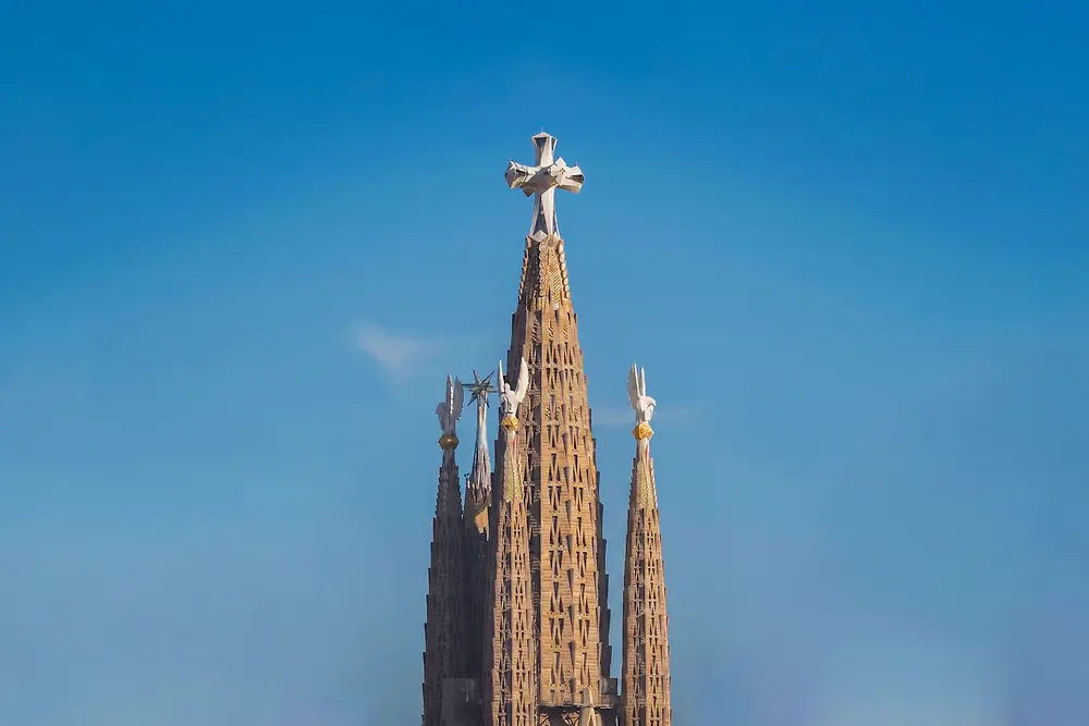 The tallest towers of the Sagrada Familia against a blue sky