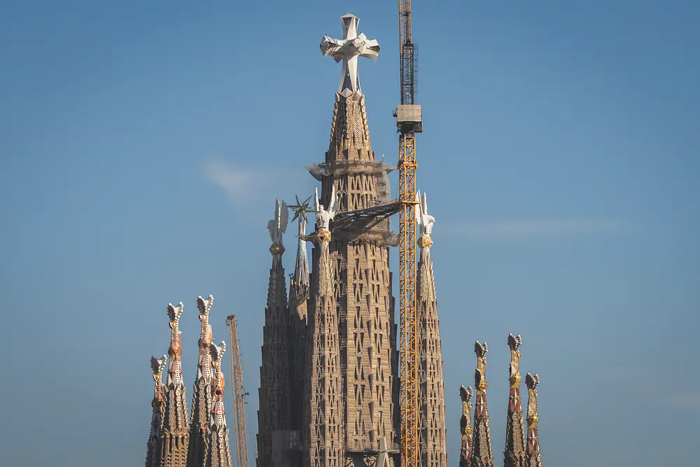 The tallest towers of the Sagrada Familia against a blue sky