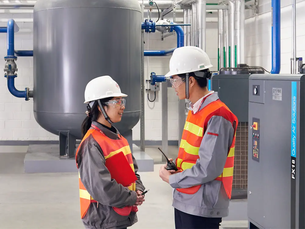 Two employees talking in production.