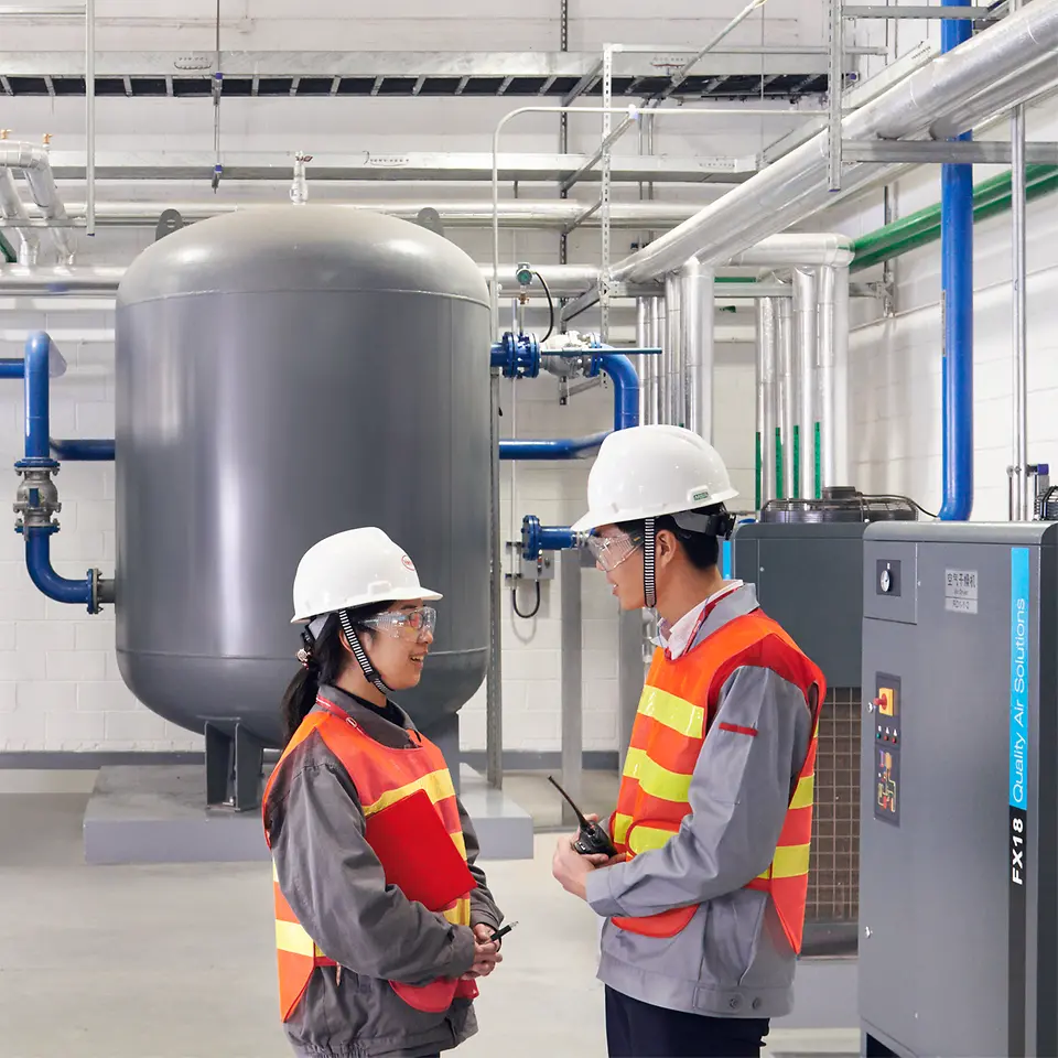 Two employees talking in production.