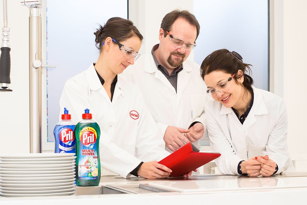 Three employees proving report in lab