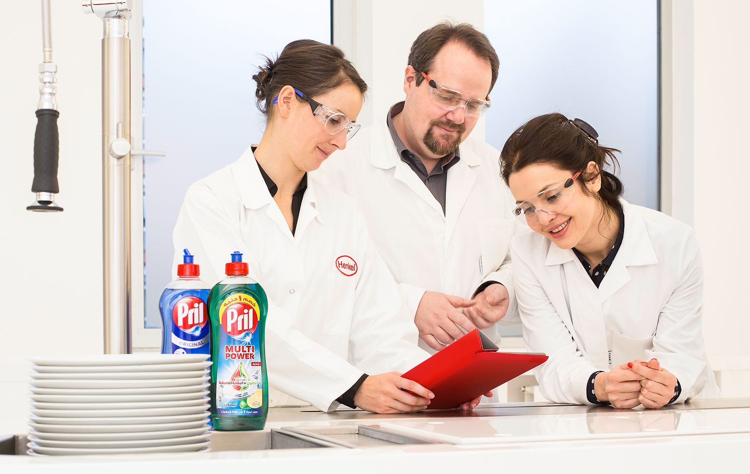 Three employees proving report in lab