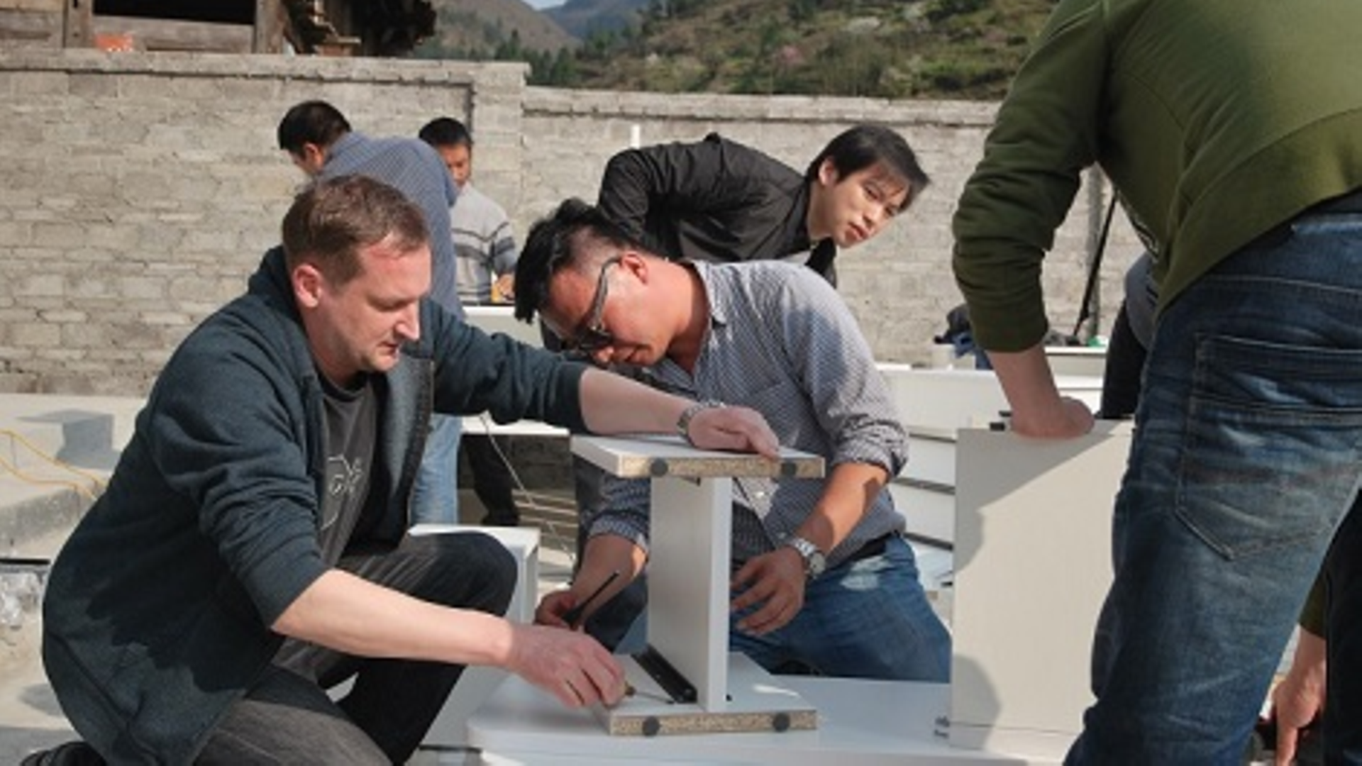Schneider (left) and his team set up the donated furniture
