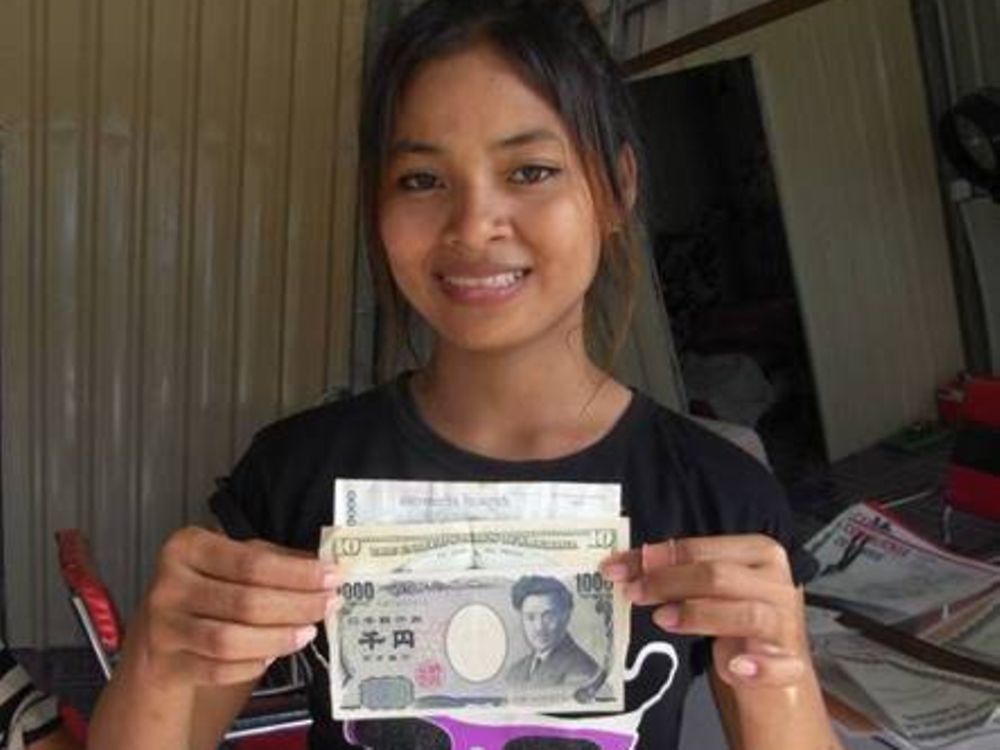Theara holds her first earnings