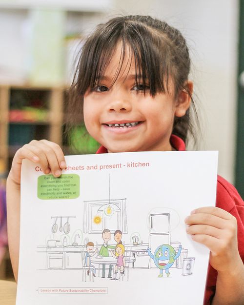 girl holding sustainability teaching materials
