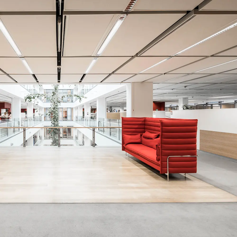 Image of lounge area with red sofas and open space in Adhesive Technologies building at Henkel headquarters.